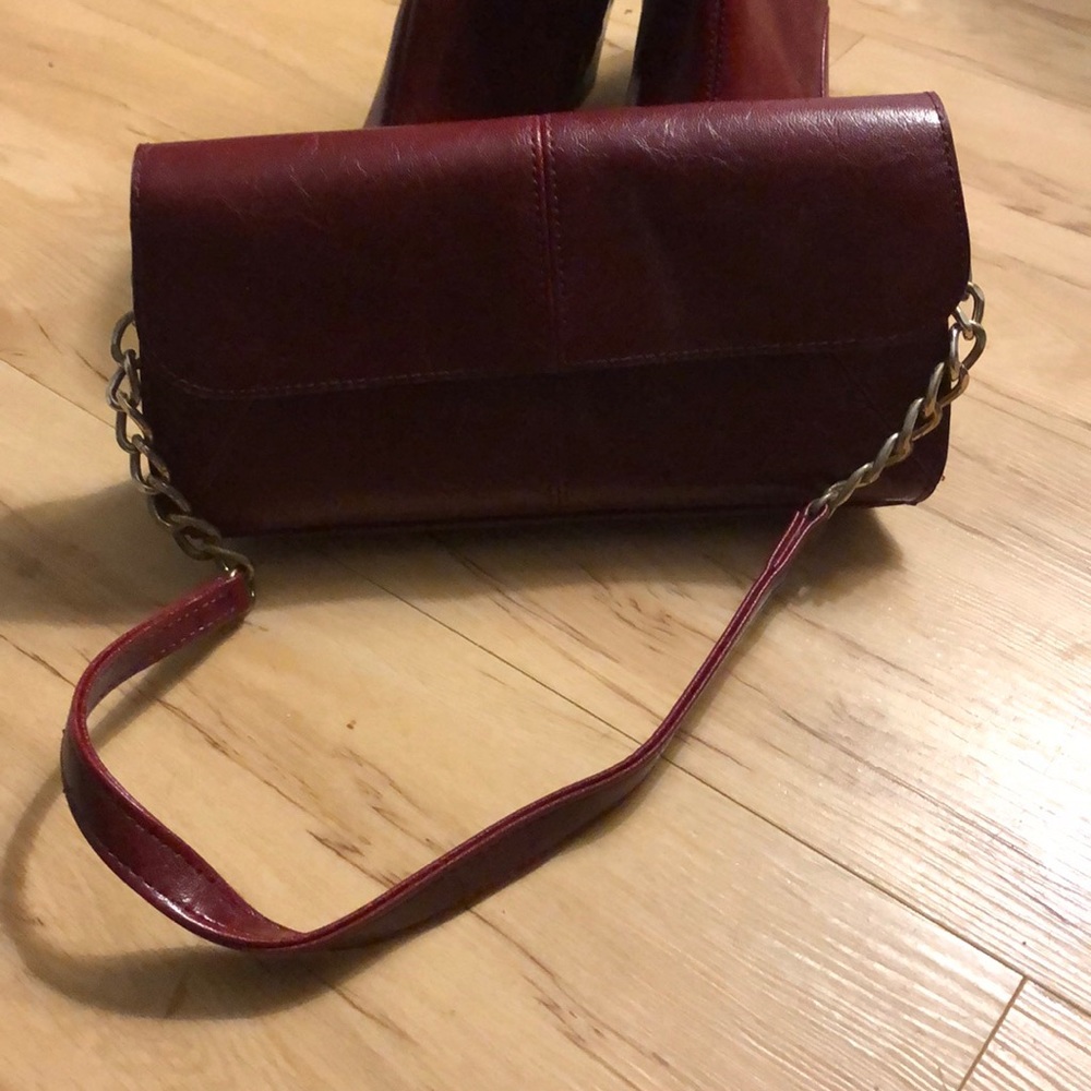 Burgundy Red clutch with gold chain accent.